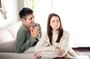 young man begging his girlfriend to forgive him