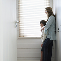 Side view of mother holding younger son