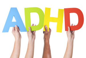 People holding the letters ADHD 