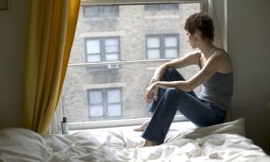 Woman In College Looking Out Her Window As She Thinks About Her Addiction To Adderrall - Addiction Hope