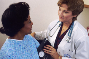 Doctor Taking Blood Pressure of woman in Treatment for Prescription Drug Addiction