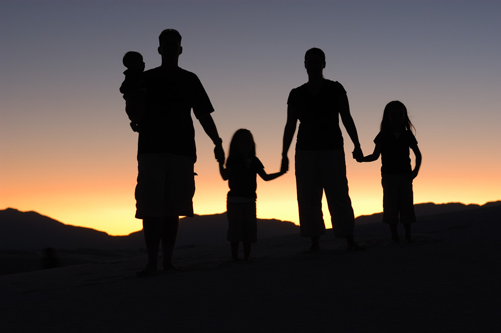 Family holding hand During a sunset