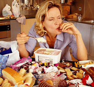 Woman Binge Eating In Her Kitchen