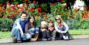 Family sitting on a curb together.