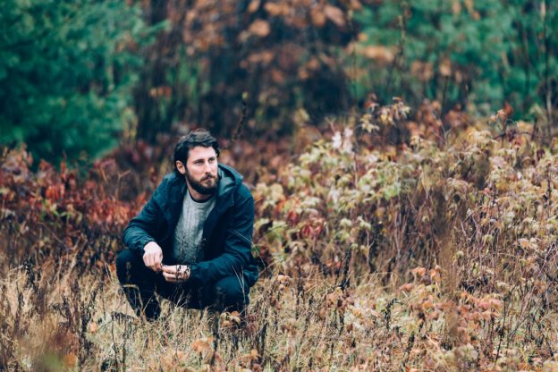 Man crouching In Filed