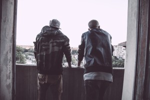 Two guys looking over a balcony