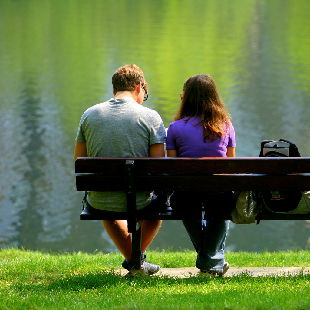 Man In Prescription Drug Addiction Treatment Sitting On A Bench With His Wife