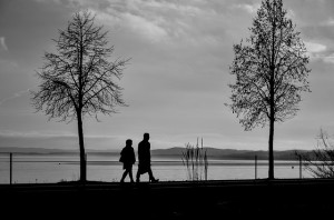 People walking near a lake discussing Alcoholism