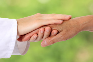 Woman hand helping senior in nature