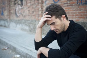 portrait of a lonely man in a urban street feeling sad