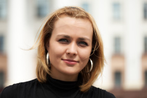 Happy young woman walking on the city street