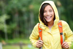 Rain woman hiking happy in forest