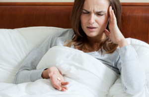 Female having terrible headache taking painkillers