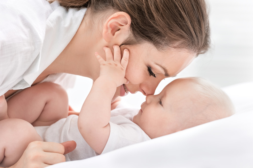 Mother playing with her newborn 