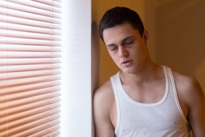 drug addict standing by window and sleeping.