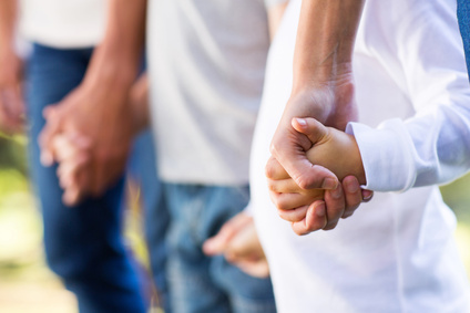 Family standing together holding hands