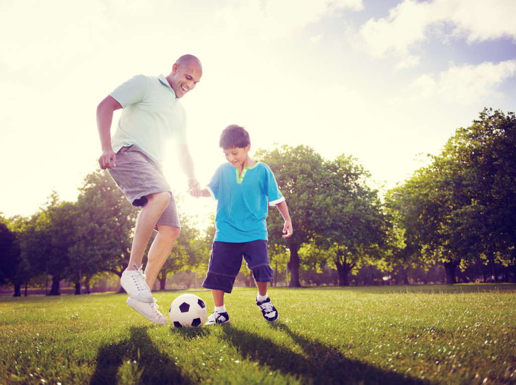 Family Father Son Playing Football Summer Concept