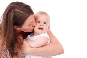 Mom kissing baby