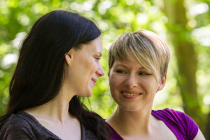 Girlfriends relaxing in park, horizontal