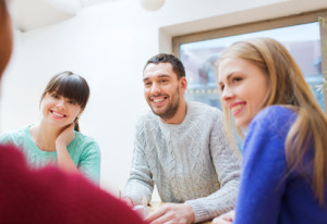 group of happy friends meeting and talking