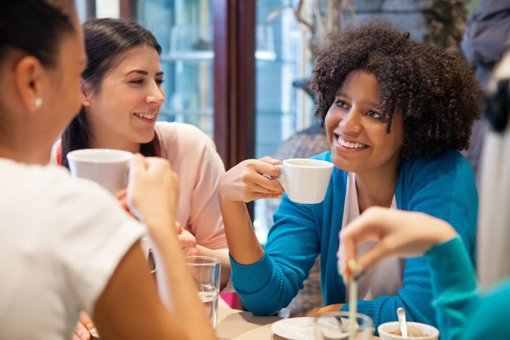 Woman drinking coffee and discussing Mothers & Opioid Abuse