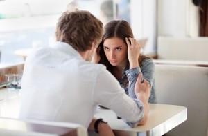 Couple having relationship problems, talking in a coffee shop