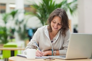 Smiling female student doing homework about a DUI topic