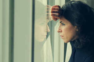 beautiful 35 year old woman stands in front of the window