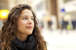 Portrait of attractive young woman gazing positively