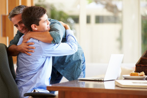 Father And Teenage Son Having A Hug
