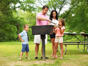 family barbecue - dad giving kids food