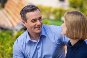 happy couple outside talking and looking at each other.