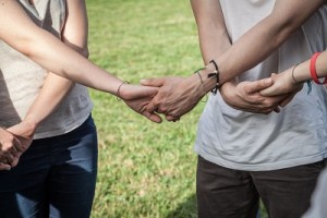 Teamwork. Hands shaking to stop Prescription Drug Abuse