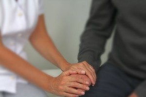 Therapist comforting male patient because residential treatment is needed