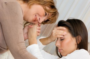 Mature woman consoling her young daughter in the living room.