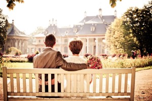 man and woman sitting on front porch swing