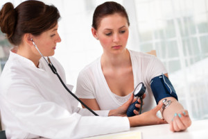 Doctor giving a lady with Fibromyalgia a physical.