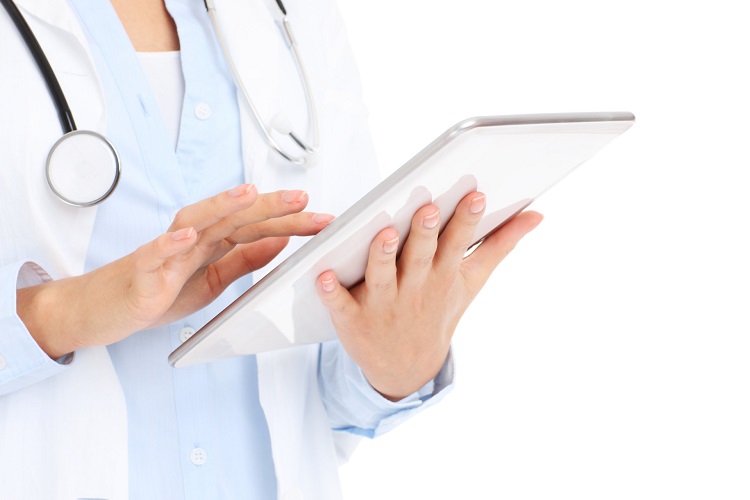 A picture of a doctor holding tablet over white background