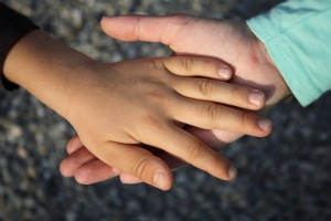 child's hand in Dad's hand