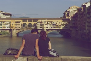 couple sitting on wall in rome