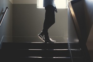 Teen walking on stairs with phone on social media