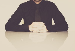 Man sitting at desk thinking about his addiction