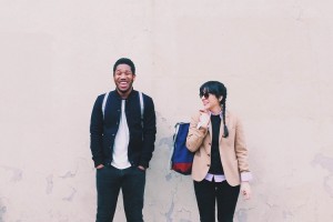 guy and girl leaning on wall discussing mixing cold medications with energy drinks