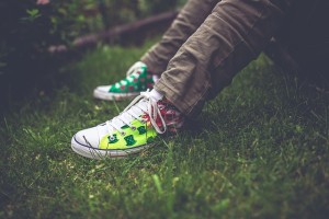 tennis shoes standing in grass