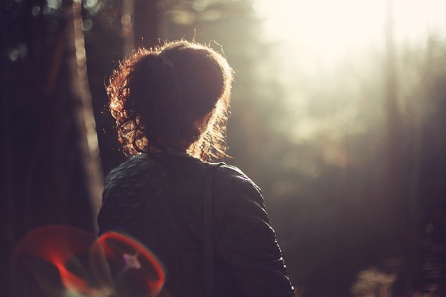 lady sitting in forest in sunset