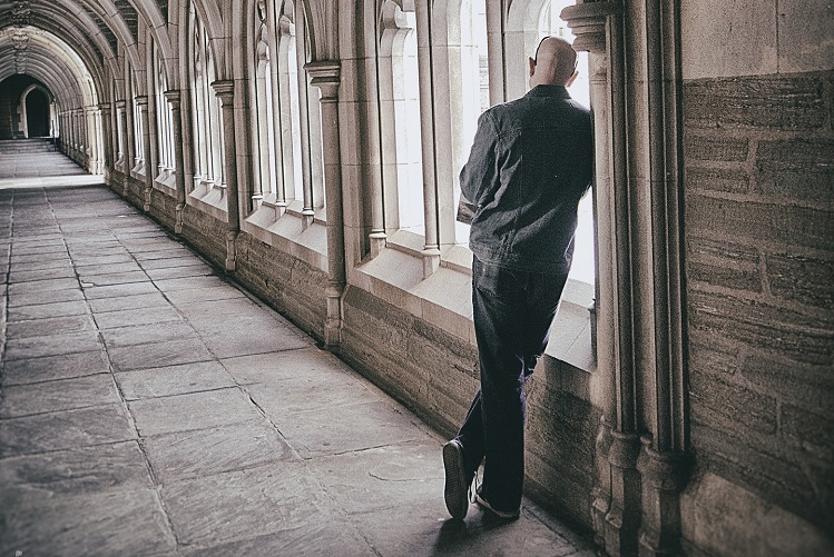 person leaning on wall