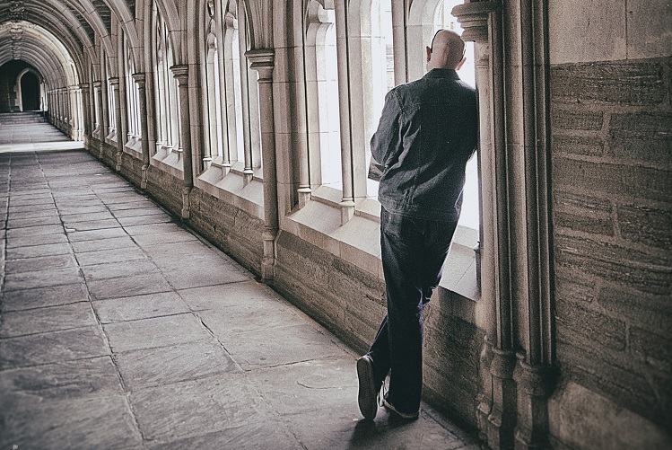 person leaning on wall