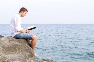 man reading Bible after overcoming Addiction