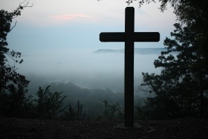 Cross on a hill in the fog