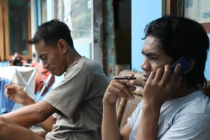 guy sitting on bench smoking